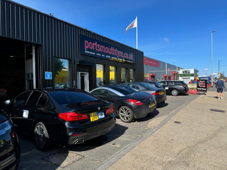 Cars having tyres fitted outside of a tyre shop business